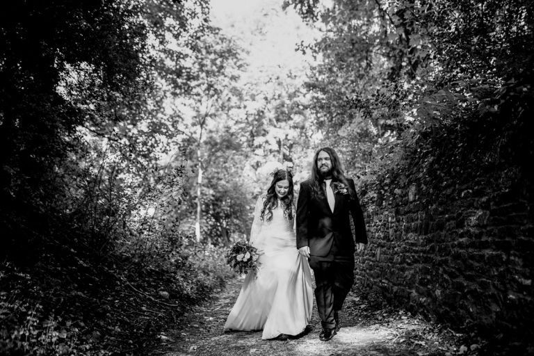 Couple take a walk in the forest at arnos vale cemetery wedding for photos