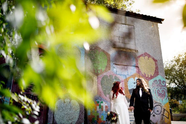 Bristol graffiti and trees are the backdrop for couples wedding photos
