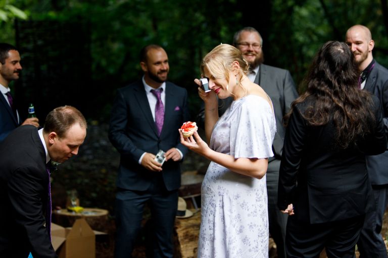 Guest takes photos while eating at wedding at Arnos Vale