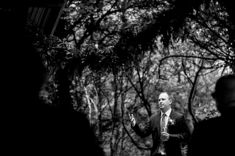 Best man gives speech in the trees at Arnos Vale wedding photos