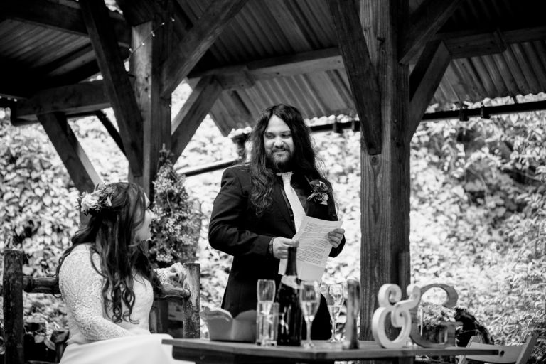 Grooms gives speech and looks at bride at Arnos Vale cemetery
