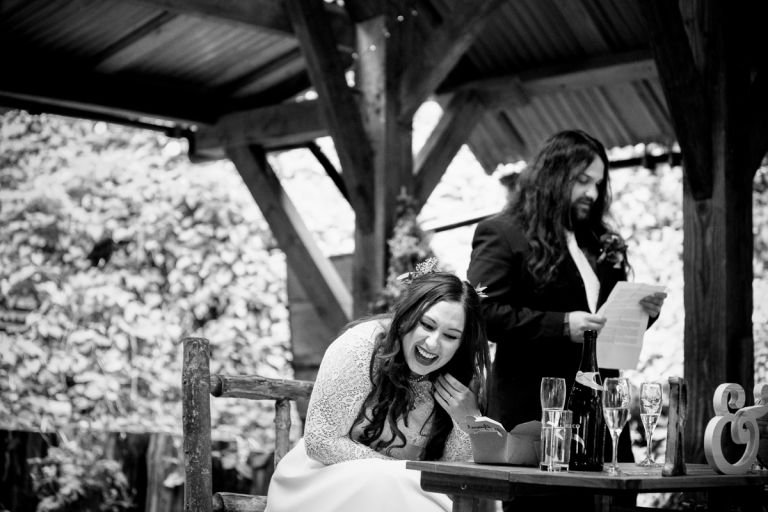 Bride laughs to Groom's speech in Arnos Vale wedding photos 
