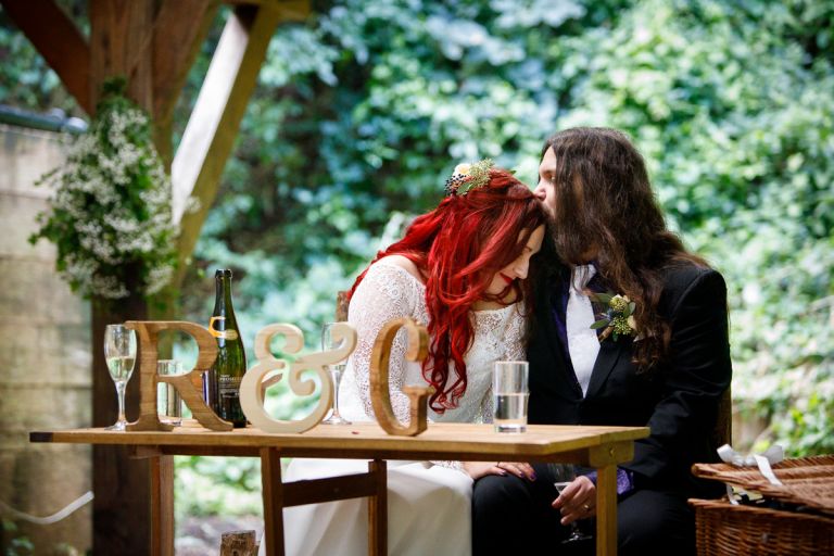Groom kisses Bride's head after he gives a speech 