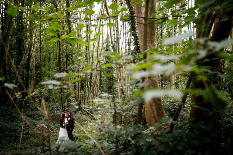 Couple surrounded by trees in the forest in Bristol forest wedding