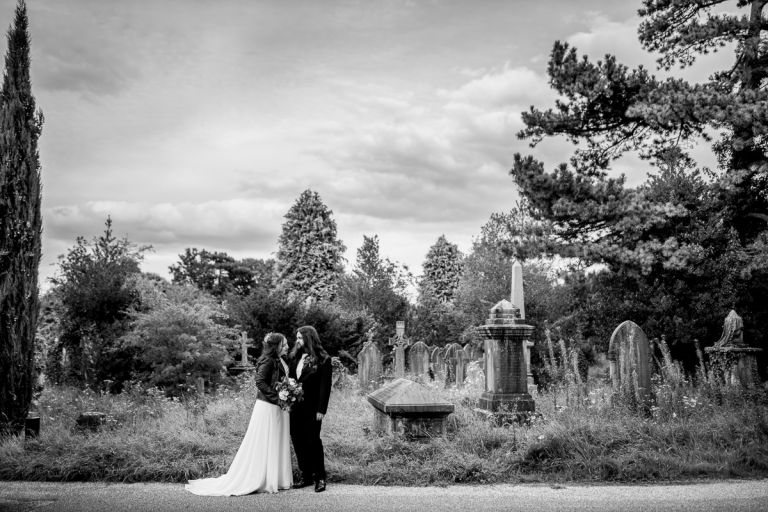Couple pose with tombstones at Arnos vale wedding photos