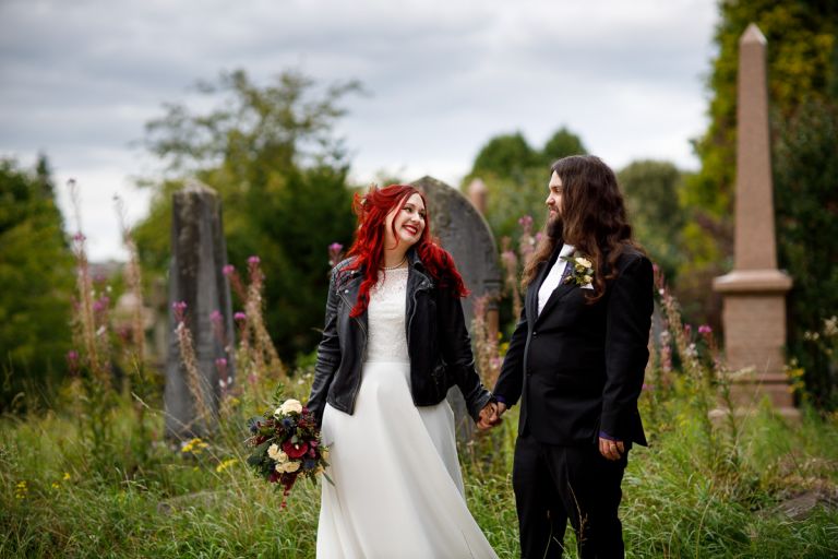 Couple in front of tombstones at their alternative wedding at Arnos Vale wedding photos