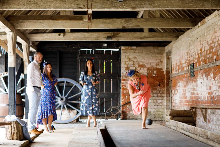 Guests play skittles at wedding at The Over Barn in Gloucester