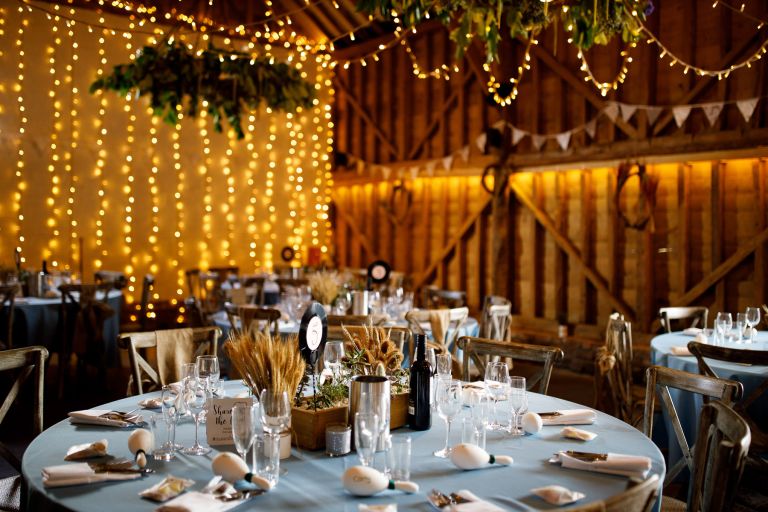 Tables and fairy lights at The Over Barn