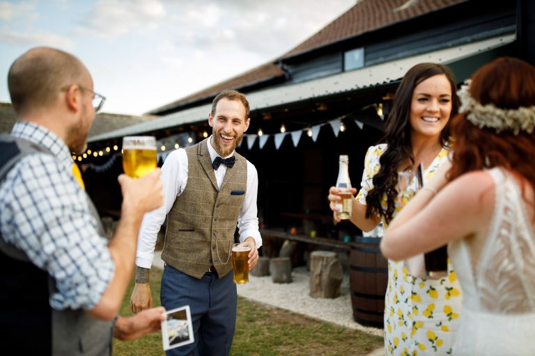 Guests toast beer at The Over Barn