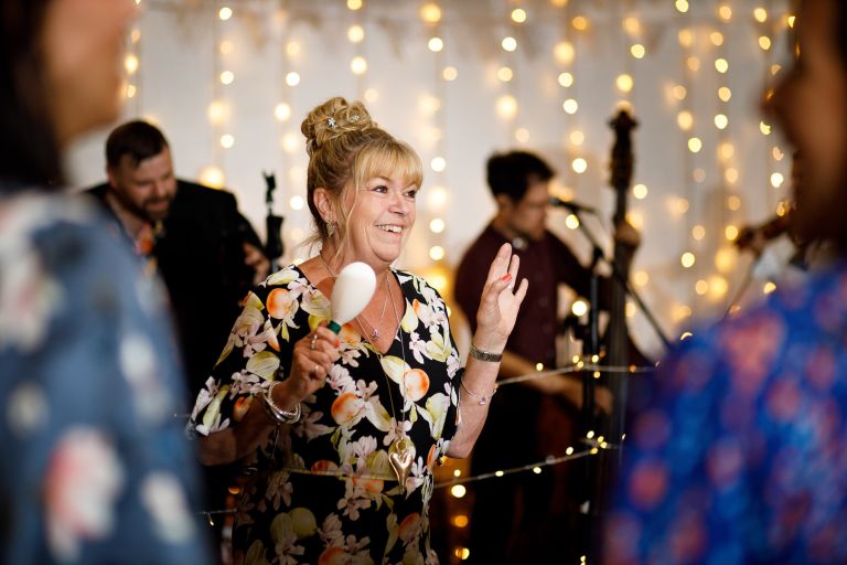 Guests in fairy lights barn wedding