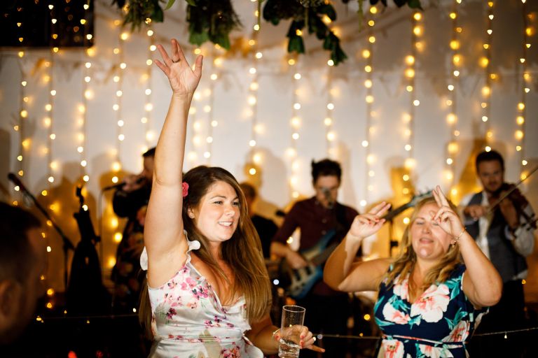 Guests dance with hands in the air to Mister Kanish