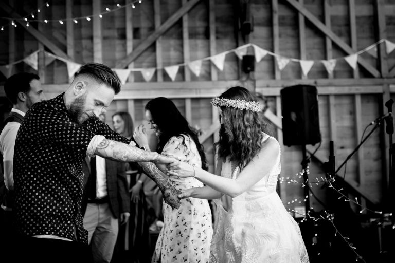 Wedding couple dance together at their wedding in gloucester barn