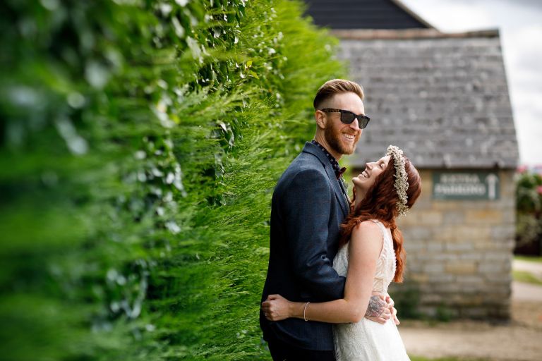 Couple laughing next to The Over Barn