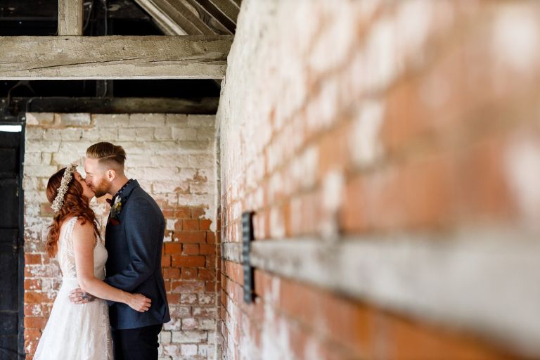 Couple kissing in the skittle alley at The Over Barn