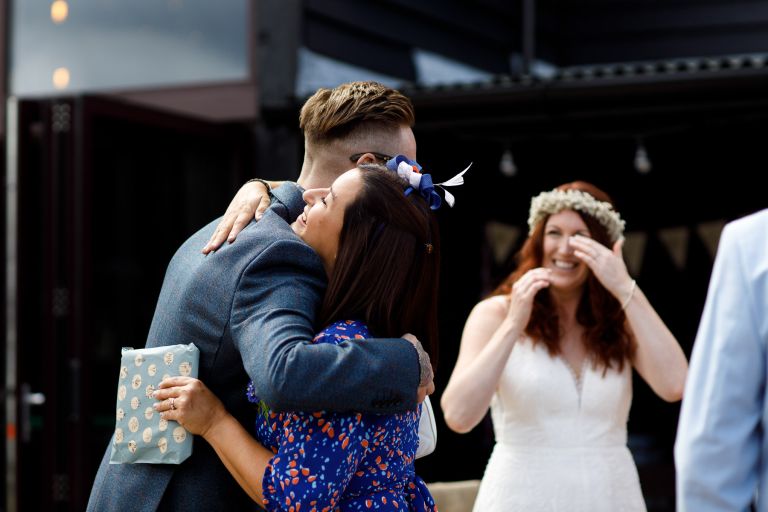 Couple greet guests before their wedding ceremony at The Over Barn