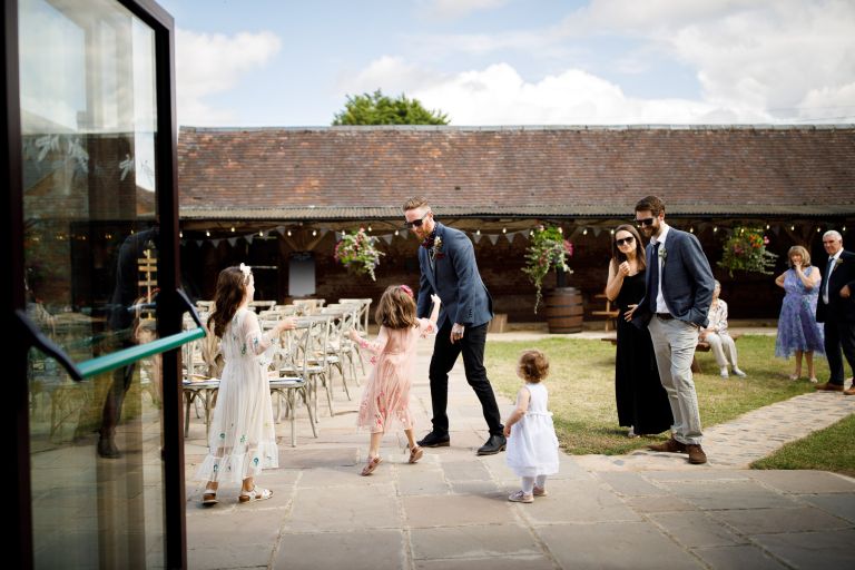 Groom plays around with family before their ceremony at The Over Barn