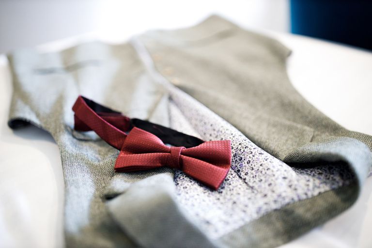 Groom wedding clothes, red bowtie and waistcoat. 