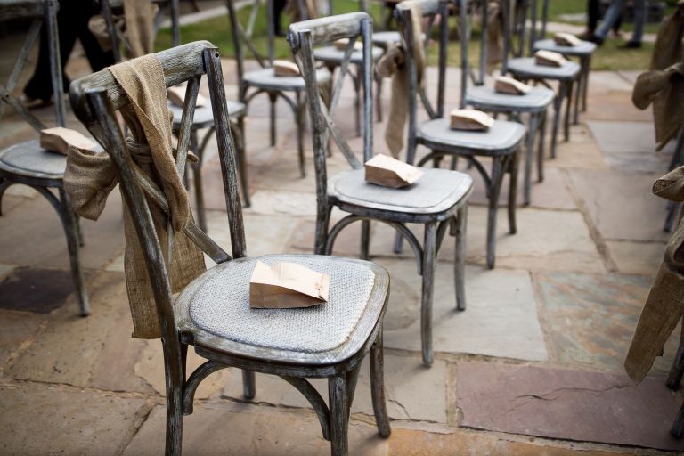 Rustic wedding chairs set up for ceremony at The Over Barn