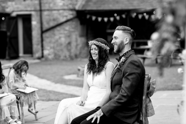Couple smile during their outside humanist ceremony at the overbarn