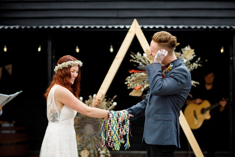 Couple laugh during hand fasting in Gloucester