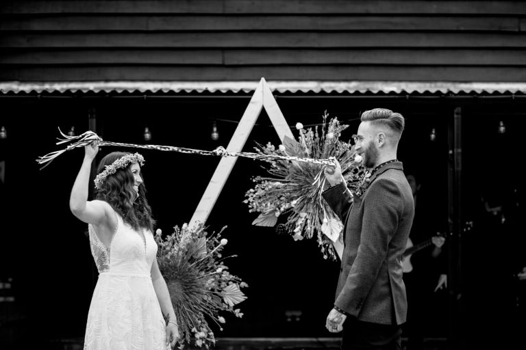 Couple tie the knot completing hand fasting at The Over Barn in Gloucester