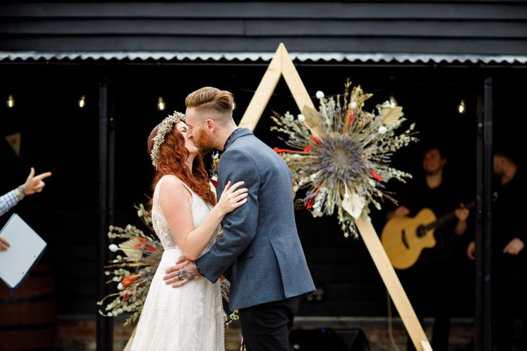 First kiss after getting married at the Over Barn in Gloucester