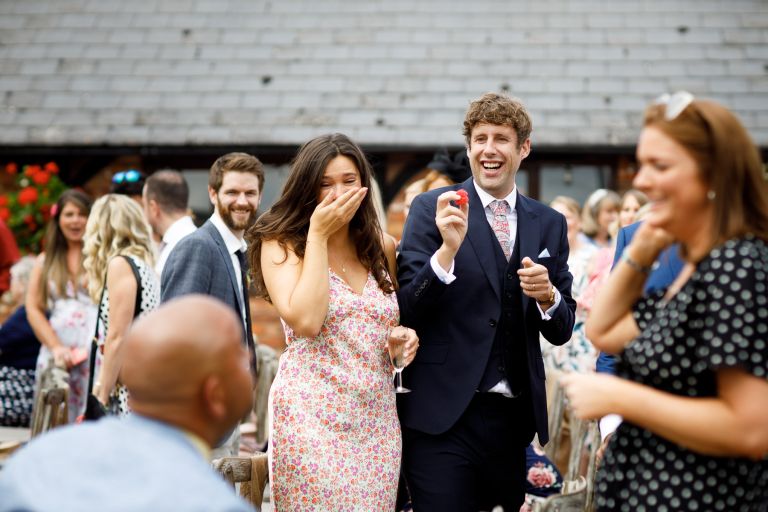 Guests play with confetti pom pom after ceremony