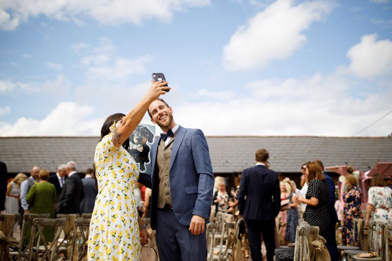 Guests take selfie with dog at wedding in Gloucester