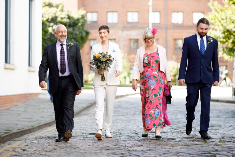 Bride walks with family in Bristol