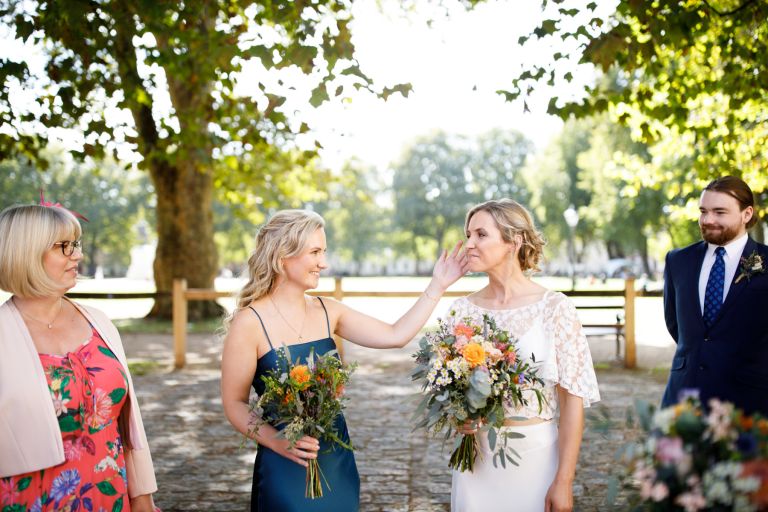 Bride and sister share a moment before wedding at same sex Bristol wedding