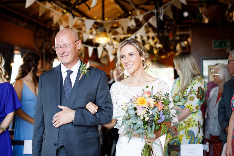 Bride walked into ceremony by her Dad at The Mud Dock same sex Bristol wedding