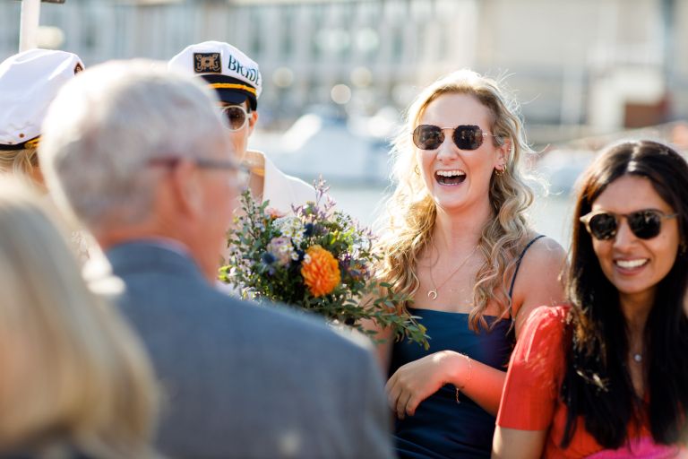 Guests laughing on boat in Bristol wedding