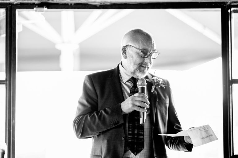Black and white photo of brides Dad giving speech 